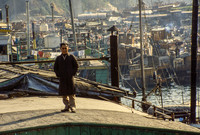 MAN STANDING ON KOWLOON ROOFTOP